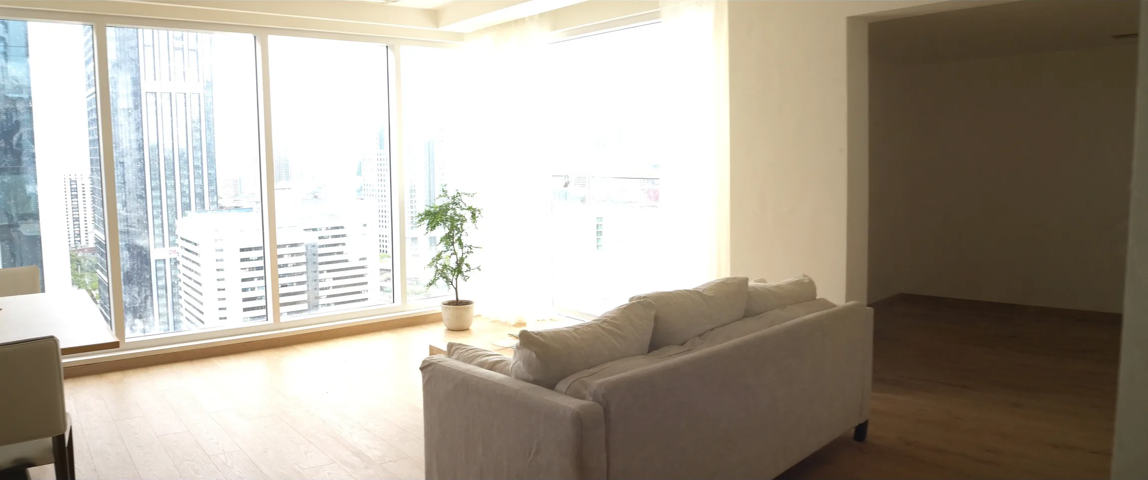 Singapore living room flooded with harsh 2pm sun through full-height windows